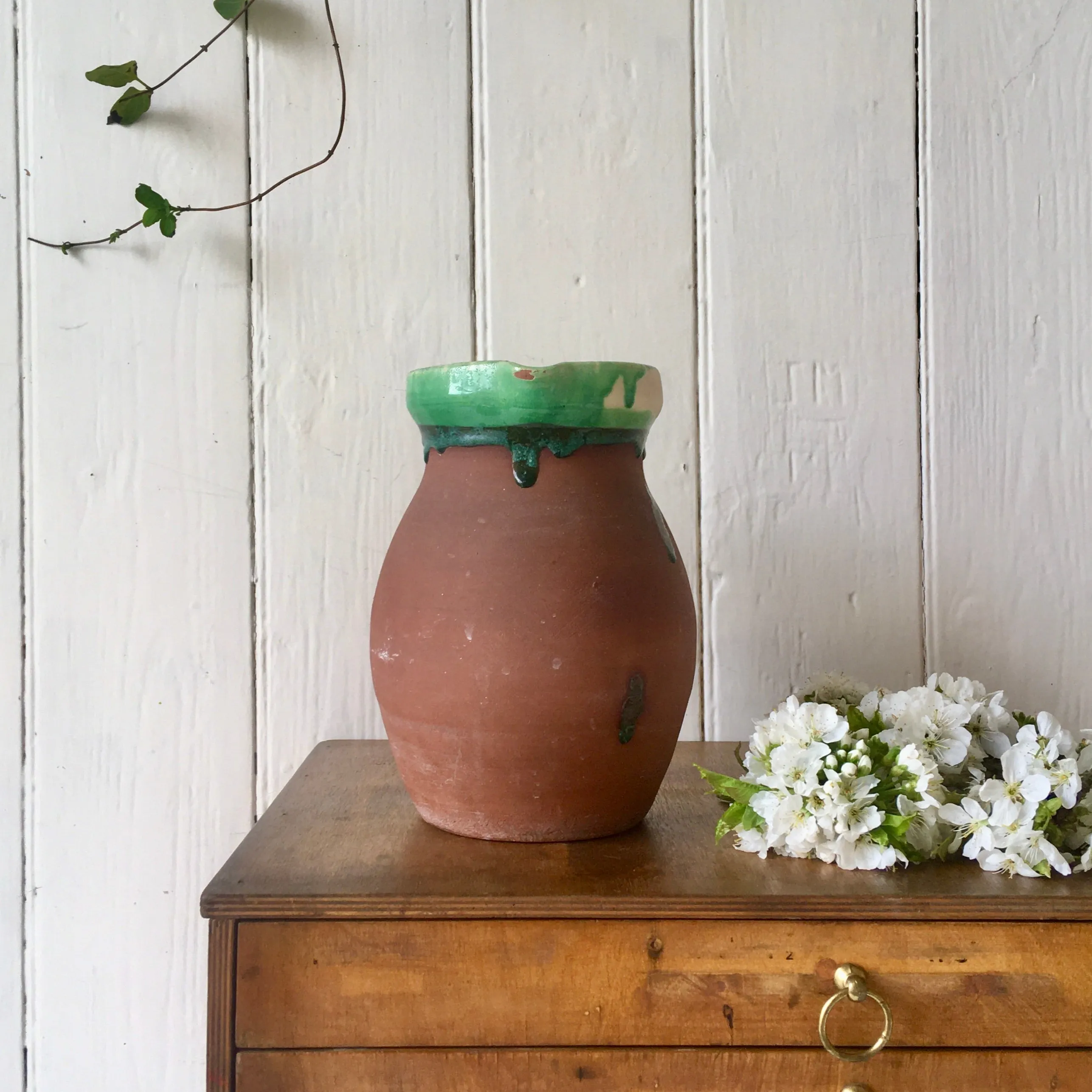 Large antique terracotta jug with green slip glazed rim